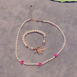The bracelet is a white and pastel and The necklace is pink and white